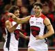 Christian Petracca celebrates with Jeff Garlett during the Demons' win against Essendon. 