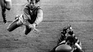 Sydney Firsts centre Bob Fulton looks aggrieved that his airborne attempted tackle is too late to stop Country half-back ...