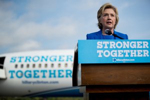 Democratic presidential candidate Hillary Clinton speaks to members of the media before boarding her campaign plane at Westchester County Airport, in White Plains, N.Y., Thursday, Sept. 8, 2016, to travel to Charlotte, N.C., to attend a campaign rally.