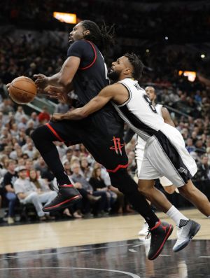 Houston Rockets centre Nene Hilario is fouled by San Antonio Spurs guard Patty Mills during game one of the western ...