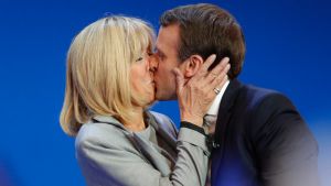 FILE - In this April 23, 2017 file photo, French centrist presidential candidate Emmanuel Macron kisses his wife ...