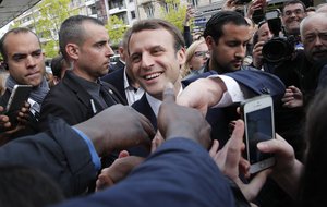 French independent centrist presidential candidate Emmanuel Macron shakes hands to supporters as he campaigns in Rodez, southern France, Friday, May 5, 2017.