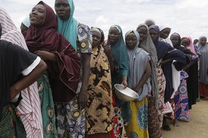 Women displaced by Islamist extremists wait for food to be handed out to them at the Bakassi camp in Maiduguri, Nigeria. Many say the dangerous journey is preferable to the hunger, humiliation and inhumane conditions in refugee camps where more than 1 million Nigerians, displaced by Boko Haram, are waiting to go home. Many are in Maiduguri, the biggest city in the northeast, the birthplace of Boko Haram