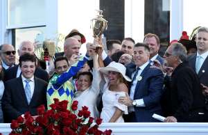Always Dreaming's team celebrates in the winner's circle with the trophy after t...