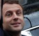 Emmanuel Macron greets well-wishers as he leaves the polling station.