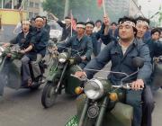 Chinese workers on motorbikes demonstrate