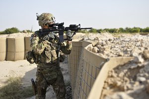 U.S. Army 1st Lt. Jeremy Kinder, a platoon leader with Troop B (Bull Troop), 1st Squadron, Combined Task Force Dragoon, inspects an area of land for hostile forces Aug. 12, 2013 around Forward Operating Base Zangabad, Afghanistan