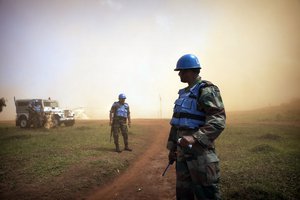 File - Peacekeepers from the United Nations Organization Stabilization Mission in the Democratic Republic of the Congo (MONUSCO) await the arrival of Lambert Mende Omalanga, Minister of Communications of the Democratic Republic of the Congo, at MONUSCO's Kanyabayonga base where he will meet with a group of rebels from the Democratic Forces for the Liberation of Rwanda (FDLR) who recently surrendered.