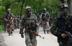 Indian army soldiers patrol during an operation against suspected rebels in Turkwangam Lassipora in Shopian south of Srinagar on May 4, 2017. Thousands of soldiers and paramilitaries are engaged in a huge anti-militant operation in Indian-administered Kashmir, where armed rebels have repeatedly attacked government forces in recent weeks. Police said government forces had surrounded at least 20 villages in the drive, launched in Shopian district in the volatile south of the disputed Himalayan region.