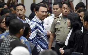 Jakarta Governor Basuki "Ahok" Tjahaja Purnama, center, talks to his lawyers after his sentencing hearing at a court  in Jakarta, Indonesia, Tuesday, May 9, 2017.An Indonesian court on Tuesday sentenced the minority Christian governor of Jakarta to two years in prison for blaspheming the Quran, a shock decision that undermines the country’s reputation for practicing a moderate form of Islam.(Bay Ismoyo/Pool Photo via AP)