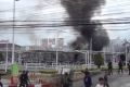 Smoke rises from an exploded vehicle outside a popular shopping centre in Pattani province, southern Thailand.