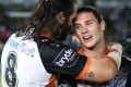 TOWNSVILLE, AUSTRALIA - APRIL 08: Aaron Woods and Mitchell Moses of the Tigers celebrate at full time during the round ...