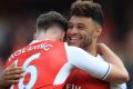 Rob Holding and Alex Oxlade-Chamberlain of Arsenal celebrate after beating Manchester United to keep their Champions ...