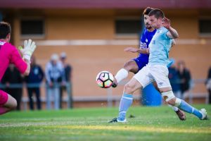 Olympic's Jordan Tsekenis gets the ball past Belconnen defence and keeper Sean Burke