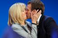 French centrist presidential candidate Emmanuel Macron kisses his wife Brigitte.