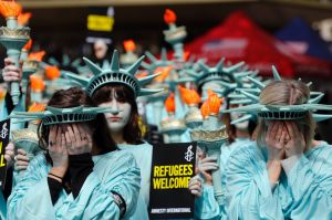 One hundred Amnesty International protesters dressed as the Statue of Liberty demonstrate outside the US Embassy in ...