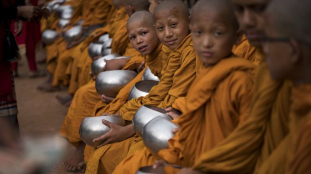 Young Buddhist monks receive donations during Buddha's birthday prayers at Boudha Stupa on May 10, 2017 in Kathmandu, Nepal.