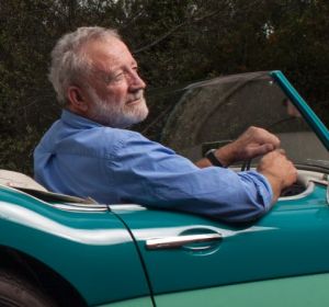 Frank Robson in the restored 1958 Austin-Healey 100-6 roadster, painted Pacific Green over Forest Green.