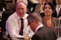 Gary Warren and his wife Michelle listen as Treasurer Scott Morrison shares their story.