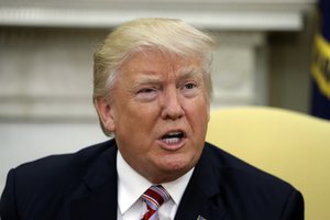 In this May 10, 2017, photo, President Donald Trump talks to reporters during a meeting with Henry Kissinger, former Secretary of State and National Security Adviser under President Richard Nixon, in the Oval Office of the White House in Washington.