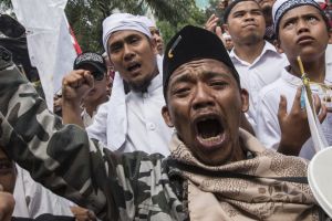 Members of various hardline Muslim groups celebrate after Jakarta's Governor was convicted of committing blasphemy.