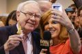 Berkshire Hathaway Chairman and CEO Warren Buffett, holds an ice cream as he poses for a selfie with Liz Claman of the ...