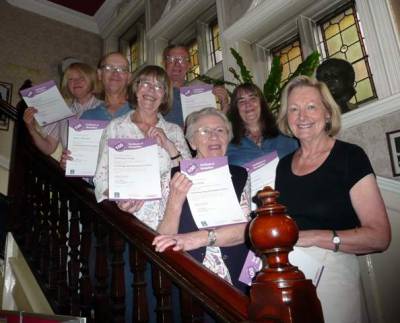 Volunteers with '100 hours of volunteering' certificates