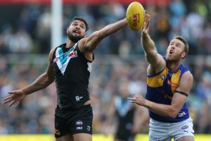 Paddy Ryder of the Power competes with Jonathan Giles of the Eagles.