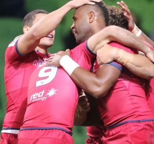 Eto Nabuli of the Reds is congratulated by his teammates after scoring against the Rebels.