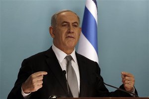 Israeli Prime Minister Benjamin Netanyahu attends a press conference in Jerusalem, Tuesday Dec. 2, 2014. Israel's prime minister fired two senior Cabinet ministers from his divided government Tuesday and said he would call early elections, plunging the country toward a heated campaign more than two years ahead of schedule.