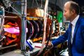 Director of the Australian Plasma Fusion Research Facility at ANU Dr Cormac Corr with the glowing MAGPIE II - a machine ...