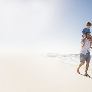 Under the Radar Florida Finds Father Carrying Son on White Sand Beach