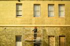 A semi-permanent installation of an imperfect gold patina covers the Providence building facade at the Abbotsford ...