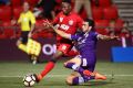 Rhys Williams, in Glory colours, tackles Adelaide Utd's Mark Ochieng during the A-League season.