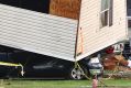 Part of a building sits on a vehicle at Prairie Lake Estates trailer home park.