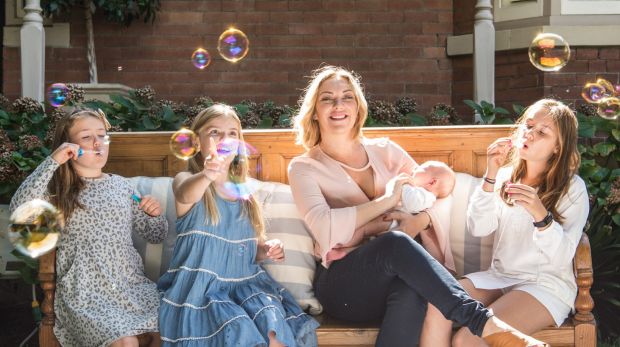 Clare Rowe with Maggie-Rose 11- white top, Bridgette 10-blue dress, Gracie 8-spotted dress and biological daughter ...