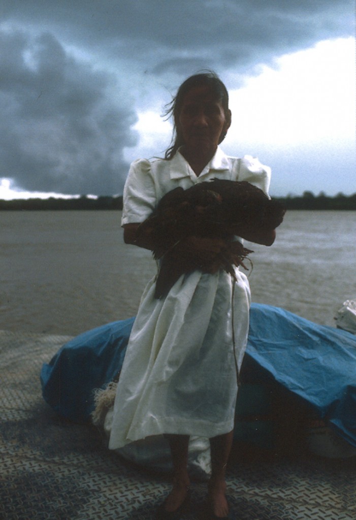 Woman on a riverboat, headed into a storm on the Rio Ucayali.