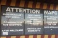 Protest signs at a Meltham shopfront suggest an erosion of community trust on planning issues. 