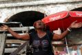 A woman prays on the street in Port-au-Prince, Haiti.