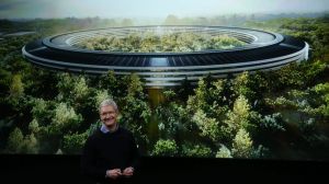 Apple CEO Tim Cook speaks in front of an artist's impression of the new campus, Apple Park. 