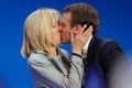 FILE - In this April 23, 2017 file photo, French centrist presidential candidate Emmanuel Macron kisses his wife ...
