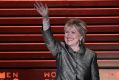 Hillary Clinton waves as she arrives onstage for an interview with Nicholas Kristof during the Women in the World Summit ...