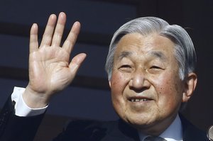 Japan's Emperor Akihito waves to well-wishers from the palace balcony during a New Year's public appearance with his family members at the Imperial Palace in Tokyo, Monday, Jan. 2, 2017.