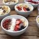 A bowl of acai with fruit and goji berries.