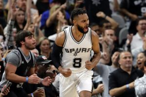 San Antonio Spurs guard Patty Mills (8) celebrates sinking a basket against the Houston Rockets during the first half of ...