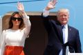 Donald Trump and first lady Melania Trump, wave as they board Air Force One for his first overseas trip as President.