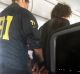 The man is escorted off the American Airlines flight after it landed in Honolulu.