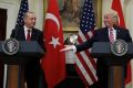 US President Donald Trump reaches to shake hands with Turkish President Recep Tayyip Erdogan in Washington on Tuesday.