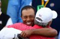 Tiger Woods and Fred Couples embrace at the 2011 Presidents Cup at Royal Melbourne