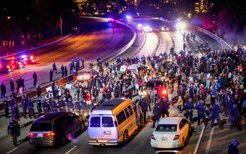Protesters block Interstate 580 in Oakland, Calif., on Monday, Nov. 24, 2014, after the announcement of the grand jury decision not to indict Ferguson police officer Darren Wilson in the fatal shooting of Michael Brown, an unarmed 18-year-old. (AP Photo/Noah Berger)
